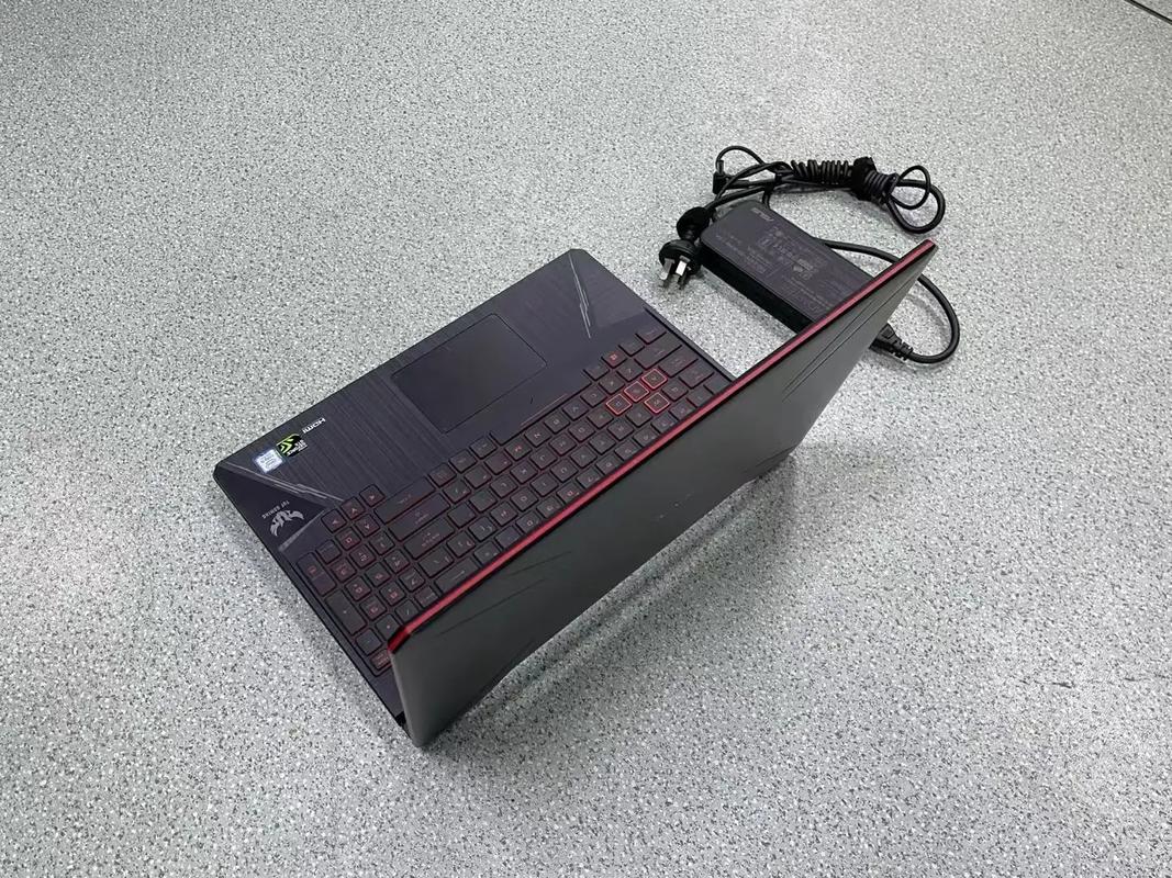 ASUS TUF Gaming laptop closed with power adapter